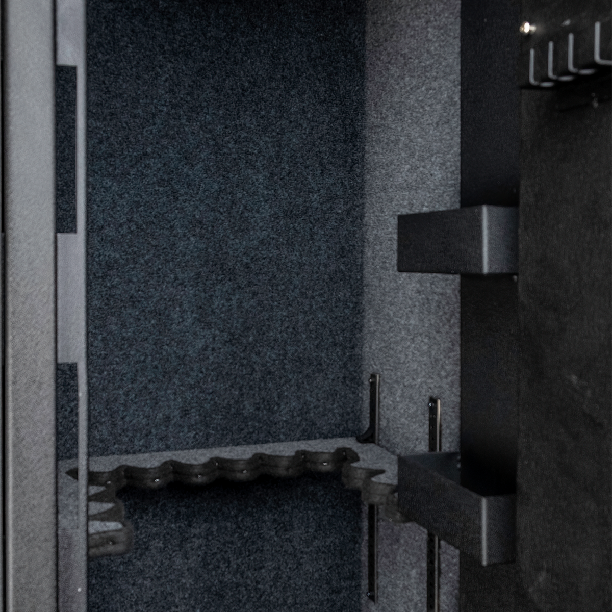 Close-up of the Spika SDD safe carpeted interior with foam barrel rest and door brackets