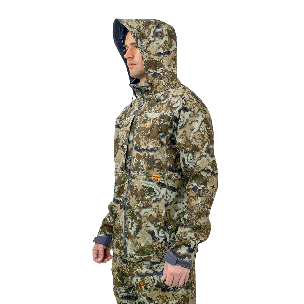 Man wearing the Spika Highpoint men's shell jacket in Biarri Camo with the hood up