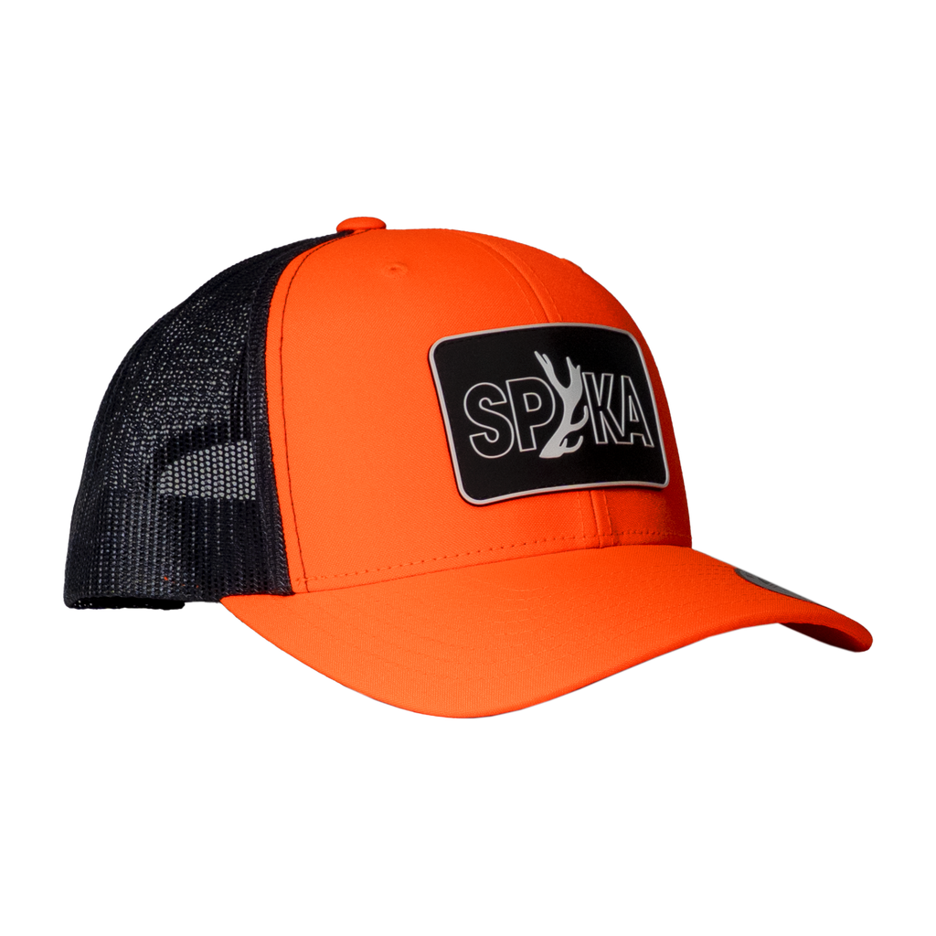 Spika Cast Antler patch trucker cap in Blaze/Charcoal, three-quarter view with mesh back