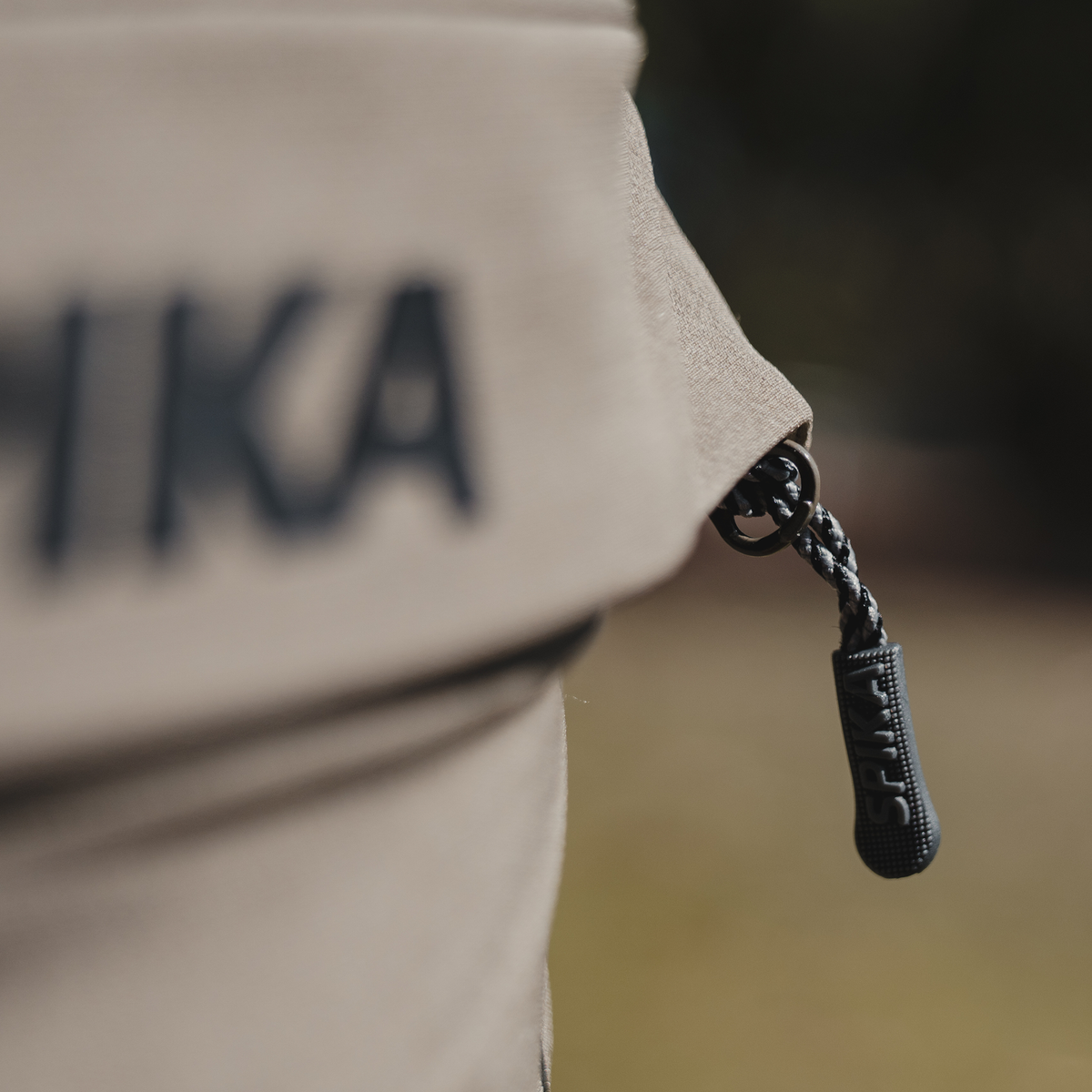 Spika Recon women's pants, close-up of the braided zip pull on the cargo pocket