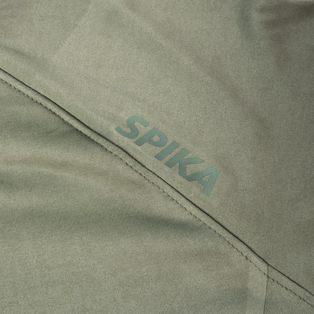 Spika Bandit women's hoodie close-up of the tonal green Spika logo on Moss Green fabric