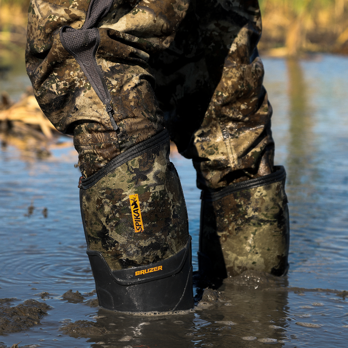 Close-up of Spika Bruzer men's Biarri Camo gumboots standing in muddy wetland water