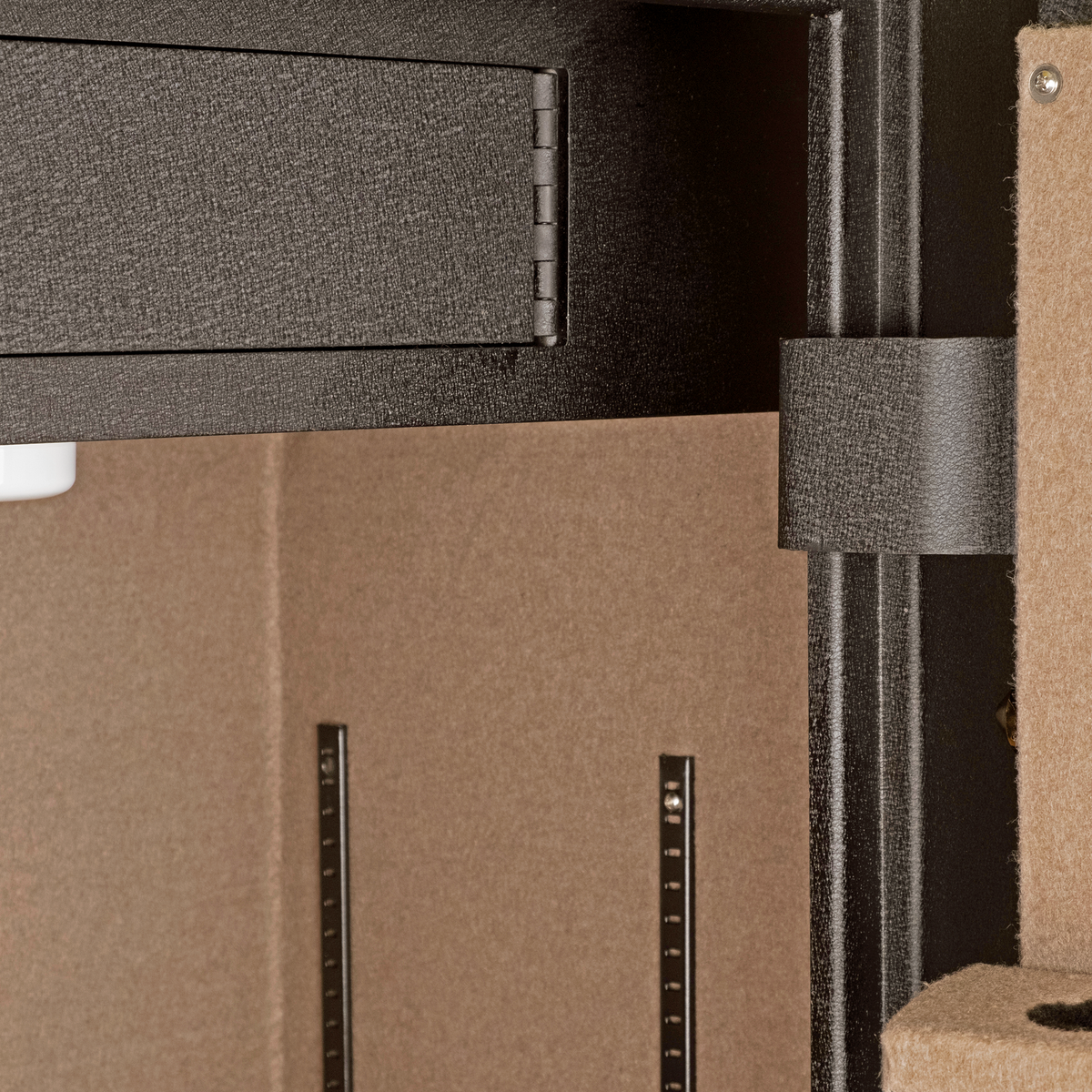 Close-up of the Spika SCH1 safe interior top shelf, adjustable rails and rifle strap