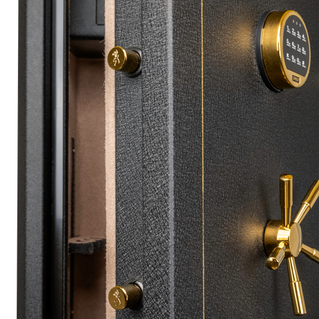 Close-up of the Spika SFABH safe keypad, brass spoke handle and locking bolts