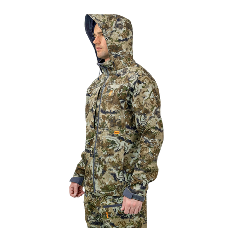 Man wearing the Spika Highpoint men's shell jacket in Biarri Camo with the hood up