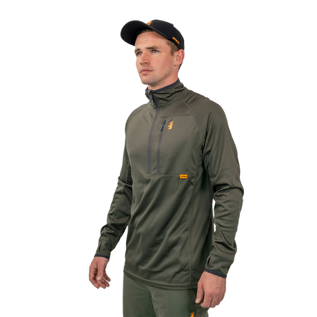 Man wearing the Spika Guide men's lightweight top in Olive, three-quarter view with cap