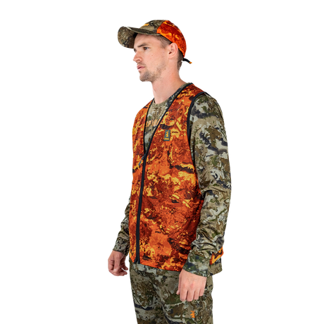 Hunter wearing the Spika Ranger vest in Biarri Blaze with a blaze cap, three-quarter view