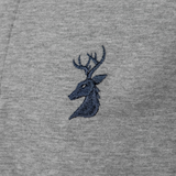 Close-up of the navy embroidered stag head logo on the Spika GO Advance kids' grey rugby jumper