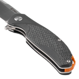 Close-up of the Spika Bushmaster Raider handle front showing textured scale, pivot and orange liner
