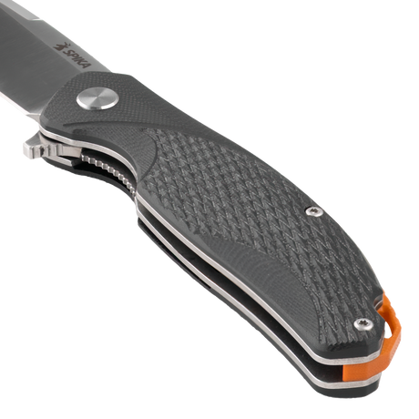 Close-up of the Spika Bushmaster Raider handle front showing textured scale, pivot and orange liner
