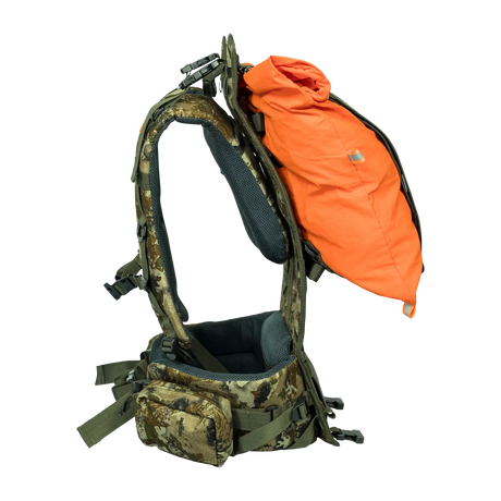 Spika Drover II Hauler frame in Biarri Camo, side view carrying an orange load bag between frame and harness