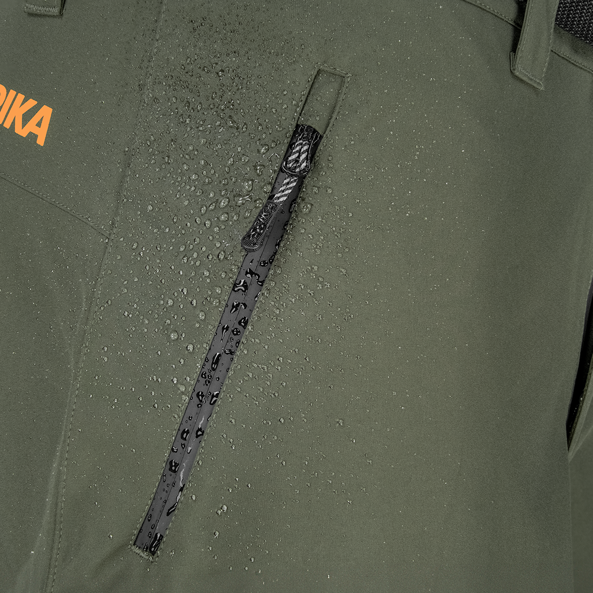 Spika Edge men's Olive pants close-up of water beading beside the waterproof zip thigh pocket
