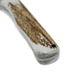 Close-up of the Spika Bushmaster Ol'Boy antler-look handle with brass pin and lanyard hole