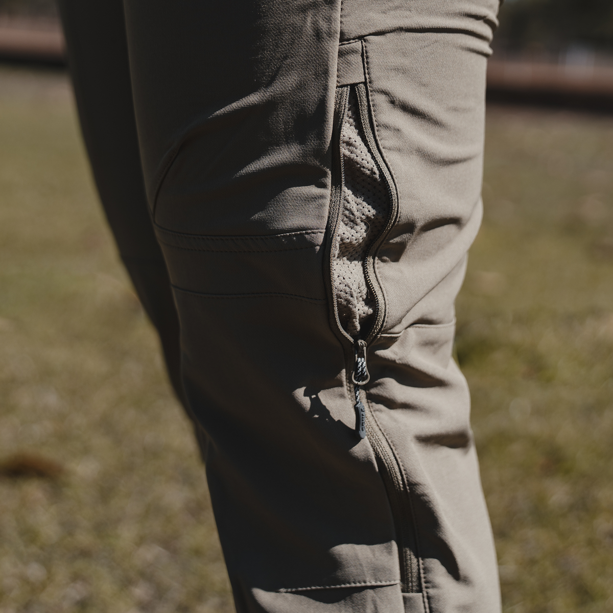 Spika Recon women's pants, close-up of the unzipped side leg vent being worn outdoors