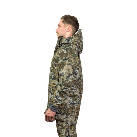 Man modelling the Spika Stalker men's hunting jacket in Biarri Camo, side profile view