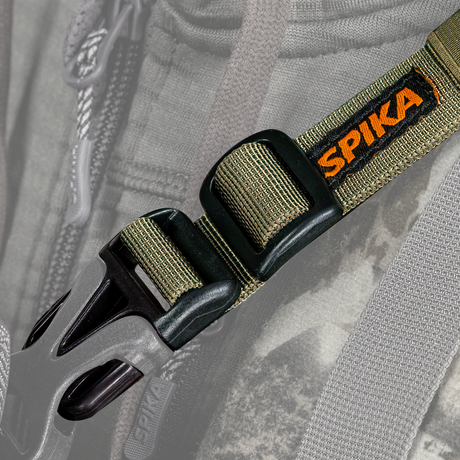 Close-up of a Spika Drover bino pack connecting strap showing the buckle, slider and orange Spika logo