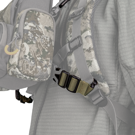 Spika Drover bino pack connecting strap clipped between a bino pack and backpack shoulder strap