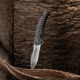 Spika Bushmaster Viper folding knife standing blade down against weathered timber and antler