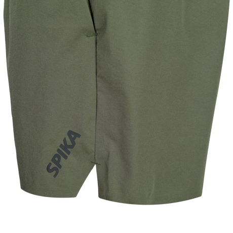 Close-up of the split hem and SPIKA leg print on Spika GO Arid men's olive quick dry shorts