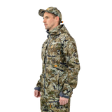 Man wearing the Spika Highpoint men's shell jacket in Biarri Camo, three-quarter view with cap