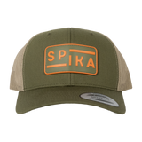 Spika Urban Waypoint trucker cap in Olive/Tan, front view of the orange rubber logo patch