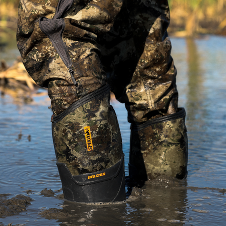 Close-up of Spika Bruzer men's Biarri Camo gumboots standing in muddy wetland water